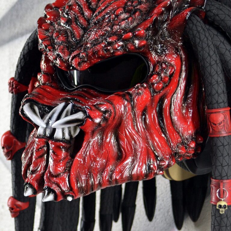 Predator mask motorcycle helmet in red with red dreads, close-up